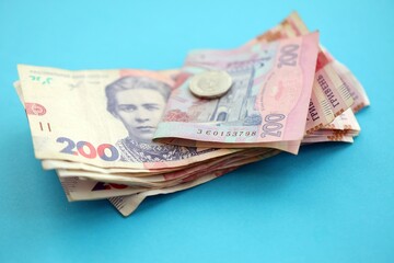 Ukrainian money bills on light blue paper background