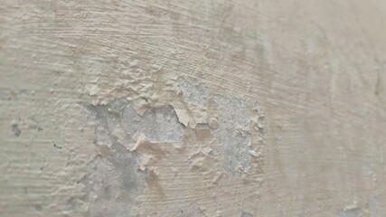 Close-up of Old Interior Wall with Peeling Paint and Damaged Texture, Showing Raw Concrete, Deteriorated Plaster, with Rough Strokes and Scratches