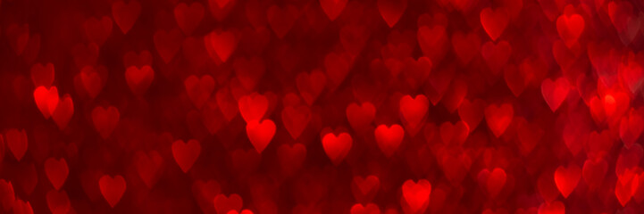 Red hearts, sparkling glitter bokeh background banner, valentines day abstract defocused texture header.