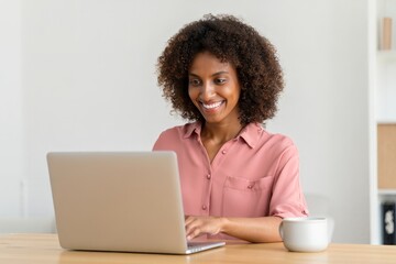 Smiling african american woman using laptop for online work from home office concept happy mood