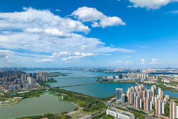An expansive aerial view of Tangxun Lake in Jiangxia District, Wuhan, China, captures the modern...