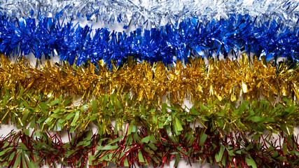 5 strips of colored tinsel in a line