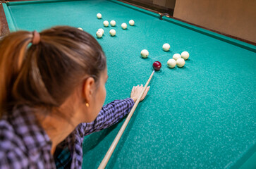 You can see beautiful female hands in black clothes deftly holding a cue and trying to drive a...