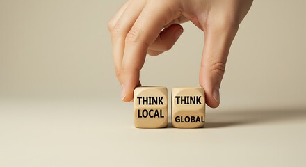 Hand Holding Dice that Say "Think Local, Think Global"