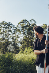 Vertical view of young traveler man admiring the landscape from train in Sri Lanka, holding the...