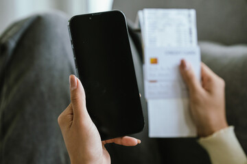 A young woman uses a laptop and credit card for online shopping, symbolizing modern finance, digital payments, e-commerce, banking, and technology-driven consumer lifestyles in today’s connected world