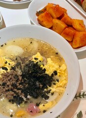 Warm and comforting kalguksu with hand-cut noodles in rich, savory broth, served with vegetables...