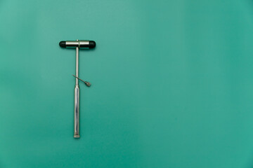 medical hammer and medical needle on green Background, Space for Text, Space for Logo