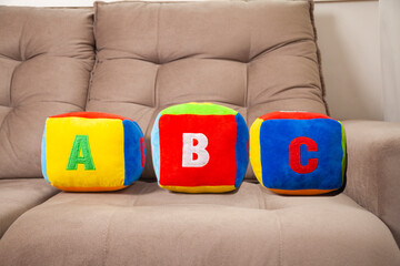 Children's plush dice with the writing A B C.