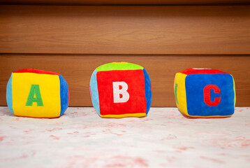 Children's plush dice with the writing A B C.