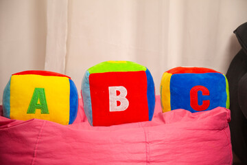 Children's plush dice with the writing A B C.