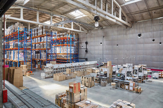 Spacious Warehouse Interior with Stocked Racks and Conveyor