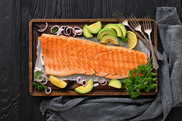 grilled whole salmon fillet on wooden board