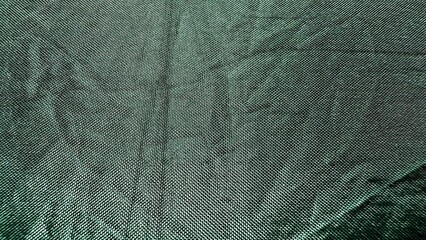 subtle green woven textile fabric with fine grid pattern and natural folds for modern background or material texture design
