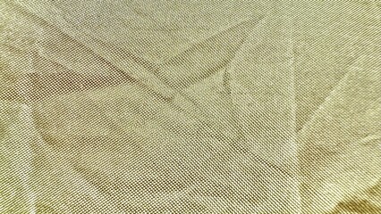 shimmering golden kevlar woven fabric closeup with diagonal folds for industrial background or protective texture design
