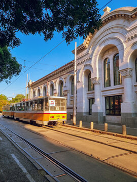 Yellow tram passing near the The Central Sofia Market Hall at sunset, Sofia, the capital of Bulgaria
