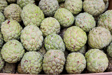 Many fresh sugar apples on sell at Asian local market. Tropical ripe sweet delicious sugar apple fruit at market.