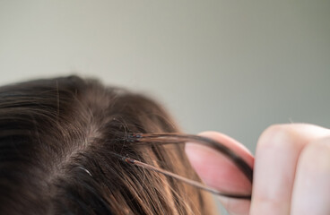 Woman with long hair extensions showing smooth strands and salon care after professional beauty treatment