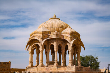 Fototapeta premium Sandstone cenotaph with intricate Rajput architecture stands as a heritage landmark, showcasing cultural history and timeless craftsmanship in Jaisalmer, Rajasthan.