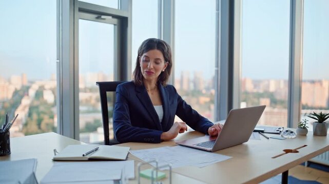 Smiling employee working computer enjoying successful project. Happy woman