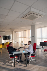 Two Caucasians Recording an Audio Podcast. 