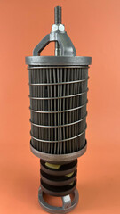 Filter Komatsu Transmission, A cylindrical industrial filter with a metal cage and visible pleated...