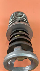 Filter Komatsu Transmission, A cylindrical industrial filter with a metal cage and visible pleated...