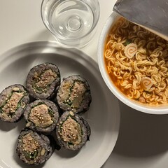 Kimbap and Ramyun, a perfect Korean combo! Enjoy savory rice rolls with vegetables, meat, and pickles alongside a flavorful bowl of spicy, comforting ramen. A satisfying meal for any time of day.