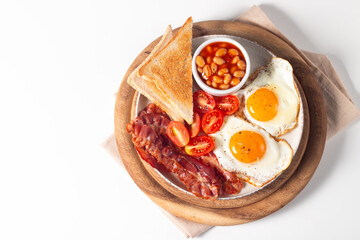 Delicious traditional English breakfast with fried eggs and bacon
