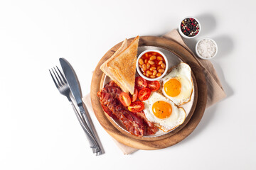 Delicious traditional English breakfast with fried eggs and bacon