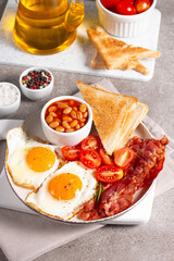 Delicious traditional English breakfast with fried eggs and bacon