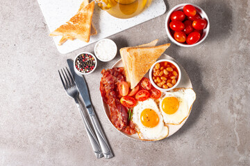 Delicious traditional English breakfast with fried eggs and bacon