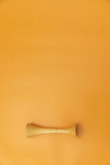 obstetric wooden stethoscope on orange Background, Space for Text, Space for Logo