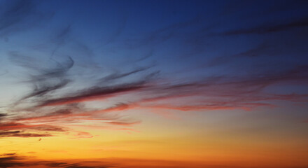 Serene Evening Sky with Magical Sunset Glow and Clouds