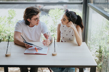 Two individuals engaged in a focused discussion, exchanging insights, and reviewing notes...