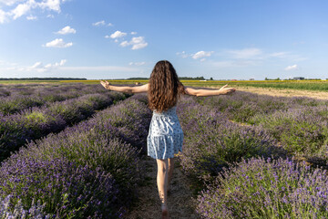 Young girl walking through a lavender field