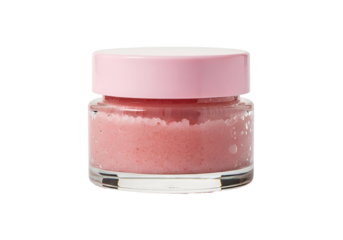 A small, transparent glass jar filled with a light pink, textured scrub sits against a plain black backdrop.