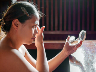 Beauty & Skincare, Beautiful woman sitting applying translucent face powder when doing make-up,...
