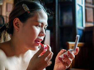 Beauty & Skincare, Woman applying lip gloss ,Lips lipstick closeup. Makeup Lipstick and Lips of...