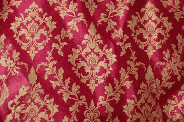 Silk fabric texture featuring a classic floral monogram in gold on pink velvet, ideal for lightweight design projects