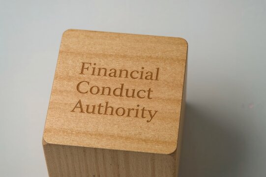 Wooden block displaying Financial Conduct Authority text