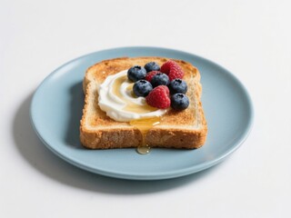 Delicious toasted bread slice topped with creamy yogurt and fresh mixed berries on a light blue plate isolated on white background