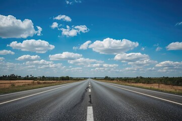 Naklejka premium Clear sky with scattered clouds over an empty paved road