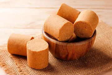 Brazilian peanut candy, traditionally known as pacoca or pacoquinha, on a wooden table