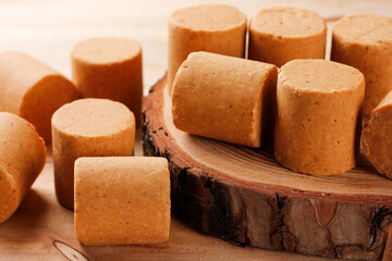 Brazilian peanut candy, traditionally known as pacoca or pacoquinha, on a wooden table