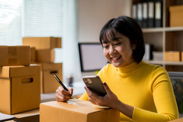 woman is sitting at a desk with a box in front of her