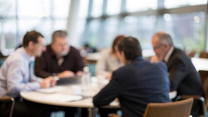 Business leaders collaborating during round table meeting — conference hall filled with attentive participants