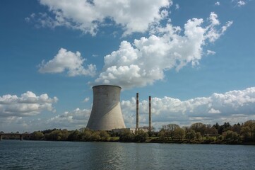 Obraz premium White steam clouds released from a nuclear facility's cooling tower, showcasing zero CO2 emissions and promoting a sustainable future through scientific innovation