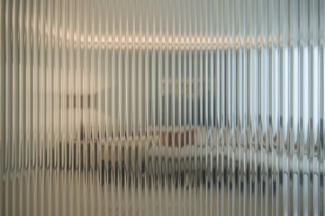 Detailed view of ridged glass surface with reflections, modern interior design, artistic arrangement of lounge area, vertical wave pattern on glass, layout with space for text