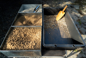 Gardening soils and pumice in metal trays with scoops